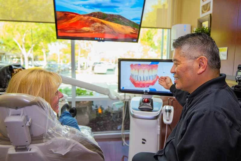 Dr. Kwan talking with a patient at Nu Smile Roseville Dental