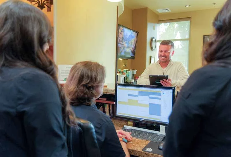 patient paying for services at Nu Smile Roseville Dental