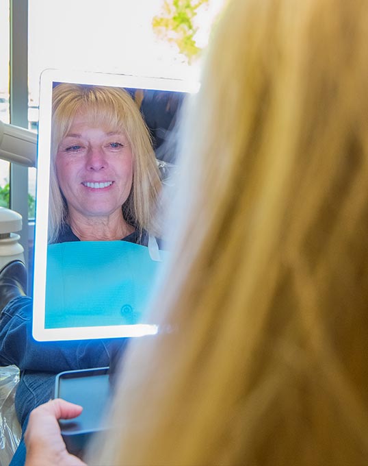 woman loving the results from dental care at Nu Smile Roseville Dental